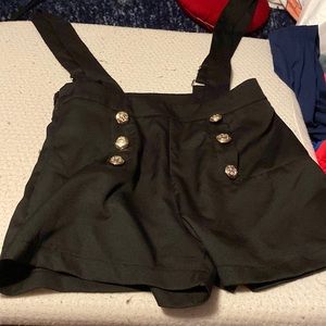Black shorts with shoulder straps